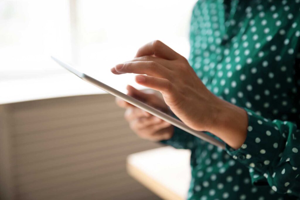Person using a tablet to take a treatment eligibility quiz.