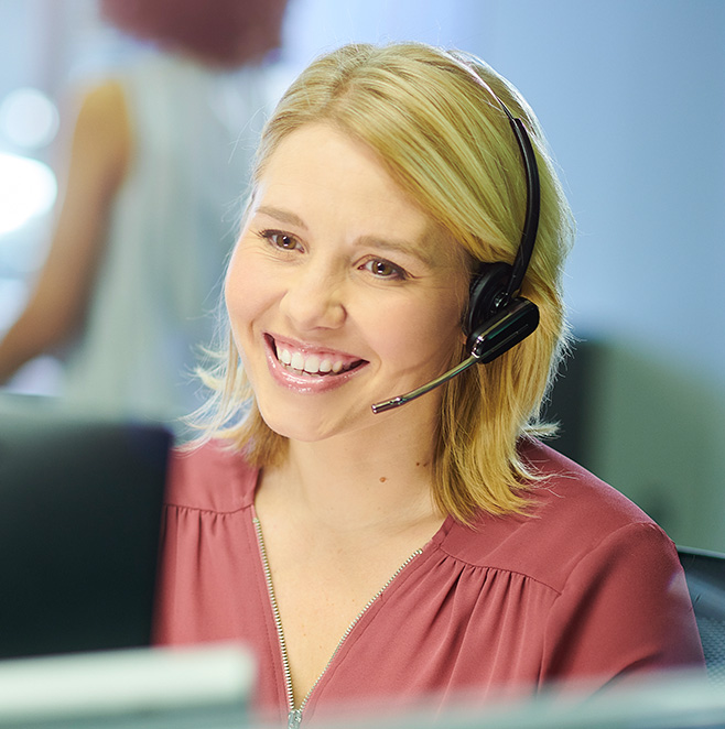 Little Green Pharma customer care team member taking a call with a phone headset.