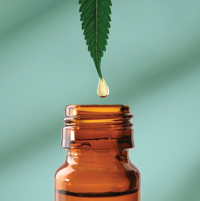 Green cannabis leaf dripping oil into a brown bottle.